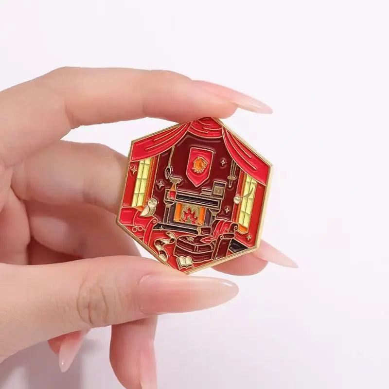 Harry Potter Fantasy movie common room pin - cartoon design cute enamel pin badge lapel pin brooches - Hand holding a red and gold decorative item with intricate design on a white background