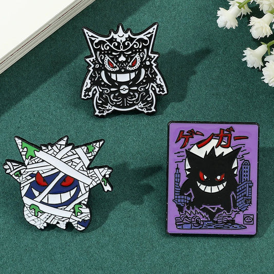 Three Pokemon Gengar enamel pins featuring different designs on a white background