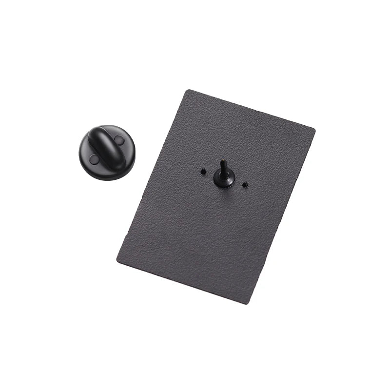 Black rectangular object with two knobs on a white background