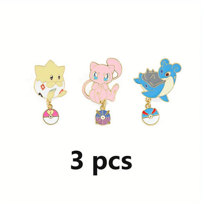 Three cartoon Pokemon character pins with Poké Ball charms on a white background
