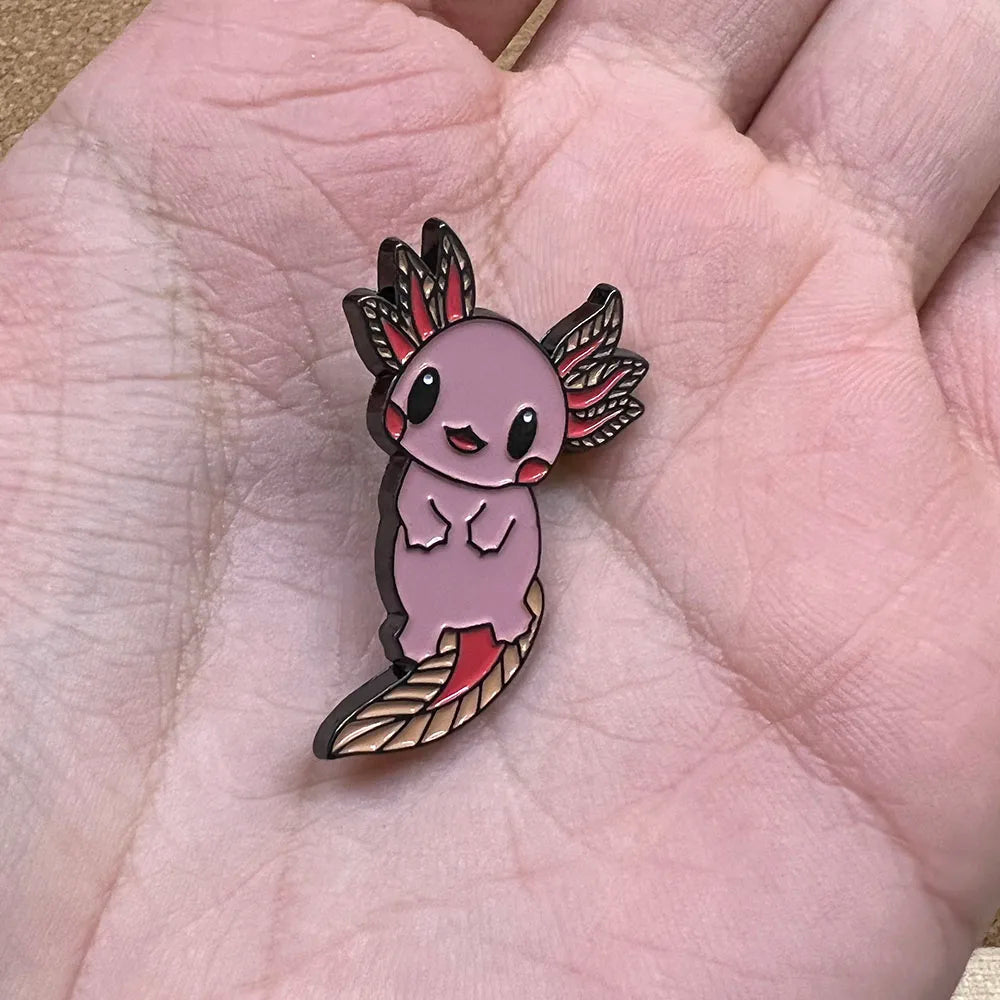 Pin with axolotl Pokemon design held in a hand