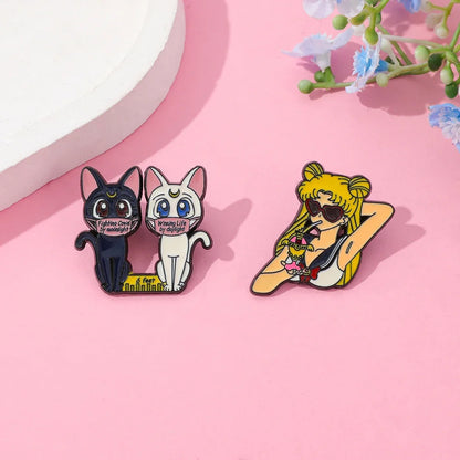 Sailor Moon anime enamel pins on a pink background with floral elements.